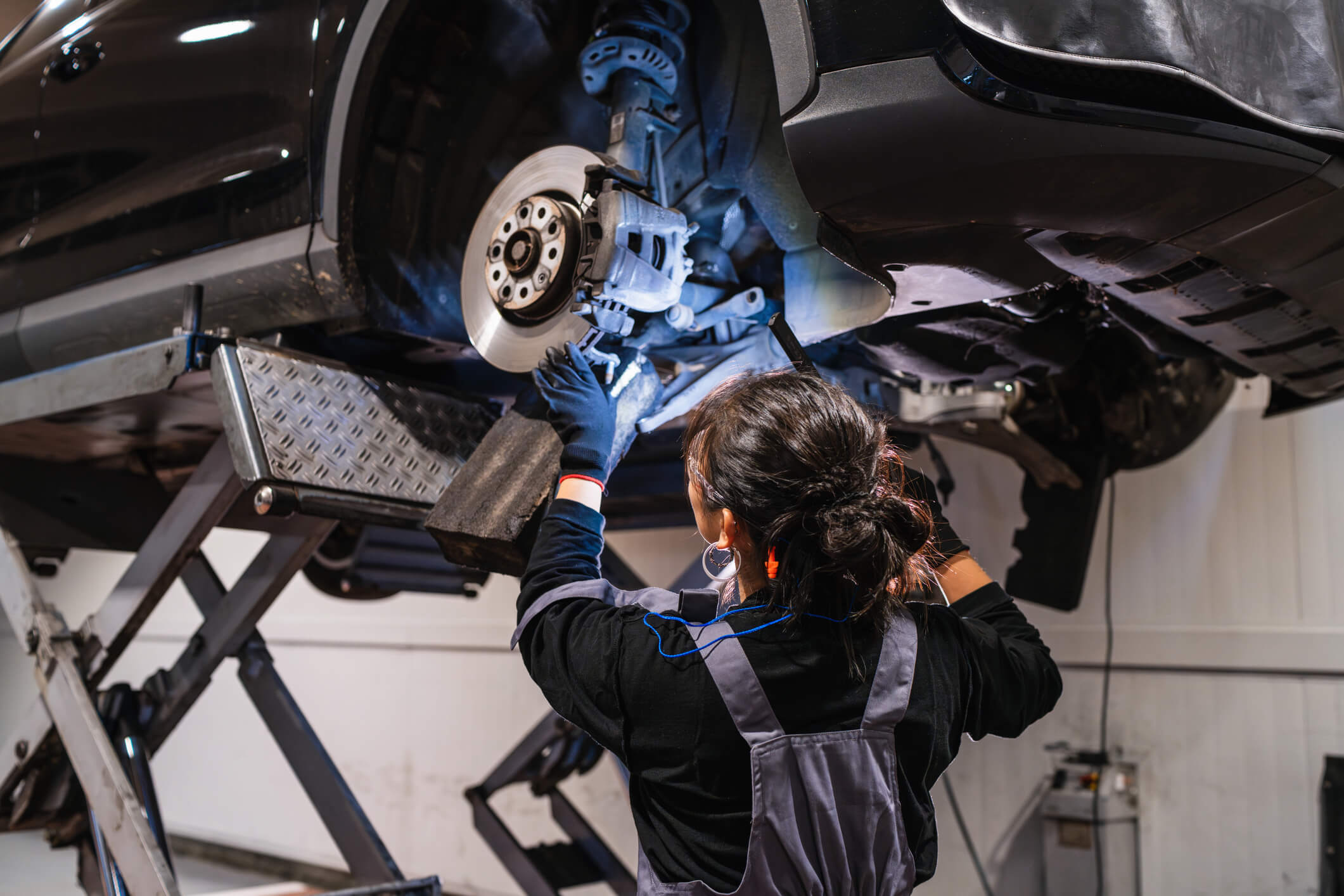 Mechanic repairing car brake system